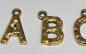 Preview: (ABC7) - Buchstaben-Set A-Z aus Metall Farbe : gold - ca. 1,2x0,85 cm unebene Oberfläche, zum Annähen / Ankleben